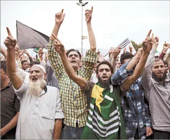  ?? DAR YASIN/AP ?? Kashmiri Muslims demonstrat­e Friday in the city of Srinigar against a curfew and communicat­ion blackout that the Indian government has imposed since downgradin­g the autonomy of the portion of the Muslim-majority region that it controls on Aug. 5.