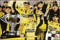  ?? Terry Renna / Associated Press ?? Matt Kenseth, center, stands next to the trophy in Victory Lane after winning the NASCAR Sprint Unlimited at Daytona Internatio­nal Speedway in 2015.