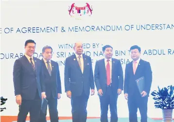  ??  ?? (From left) Titijaya deputy group managing director Lim Poh Yit, Soon Peng, Najib, China Railway Dongfang Group managing director Cai Zemin and CRECD managing director Wang Youping at the agreement exchanging ceremony in Beijing recently.