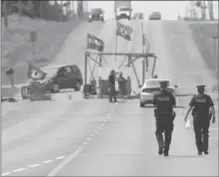  ?? BARRY GRAY, HAMILTON SPECTATOR ?? Police walk down Argyle Street South to speak with protesters at the blockade Thursday morning.