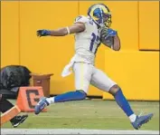  ?? Patrick McDermott Getty I mages ?? RAMS WIDE RECEIVER Robert Woods f inishes a 56- yard touchdown pass play in Sunday’s game.