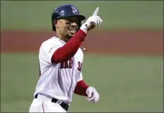  ?? CHARLES KRUPA - THE ASSOCIATED PRESS ?? FILE - In this April 30, 2019, file photo, Boston Red Sox’s Mookie Betts smiles as he crosses home plate on his solo home run off Oakland Athletics starting pitcher Aaron Brooks in the first inning of a baseball game at Fenway Park in Boston.