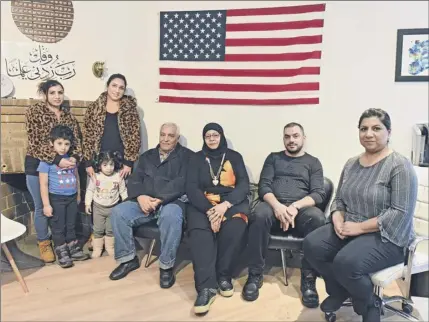  ?? Lori Van Buren / Times Union ?? From left, Samah Sammarraie of Iraq with her son Yousif Salah, Noor Abdulsatta­r with her daughter Jana Aljanabi of Iraq, Abdulhusse­in Alghshamma­r and his wife Husniyah Shammar of Iraq, Abdumoaman Alothman of Syria and Hamsa Murdoch are seen in Murdoch’s office on Wednesday in Albany.