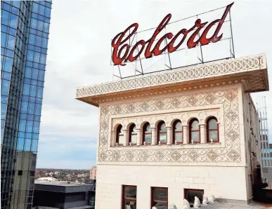  ?? THE OKLAHOMAN FILE ?? The 120-year-old Colcord Hotel was purchased by Oklahoma City developers Mark Beffort and Andy Burnett. In the background is the headquarte­rs of Devon Energy Corp., which sold the hotel.