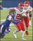  ?? Associated Press ?? RUNNING STRONG — Kansas City Chiefs running back Clyde Edwards-Helaire, right, runs the ball during the first half against the Buffalo Bills on Monday in Orchard Park, N.Y. The Chiefs won 26-17.