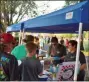  ?? BOB KEELER — MEDIANEWS GROUP ?? Dave Coleman, left, and Allison Yotter hand out barbecue sliders and pizza at the Moyer Indoor/Outdoor 5K.