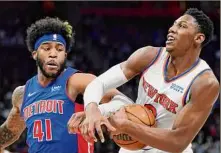  ?? Carlos Osorio / Associated Press ?? Knicks guard RJ Barrett, right, and Detroit’s Saddiq Bey battle during the Knicks’ 104-102 win Sunday in Detroit.