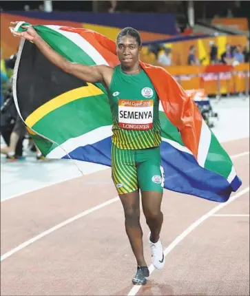  ?? Dita Alangkara Associated Press ?? SOUTH AFRICA’S Caster Semenya takes a victory lap after winning the women’s 800 meters in last year’s Commonweal­th Games. The sport has sought to regulate Semenya and others like her, and she’s fighting back.