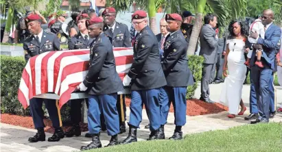  ?? AP PHOTOS ?? Myeshia Johnson, wife of Army Sgt. La David Johnson, follows his casket during his burial in Hollywood, Fla., Saturday. Johnson was killed with three other colleagues in an ambush by extremists in Niger on Oct. 4.