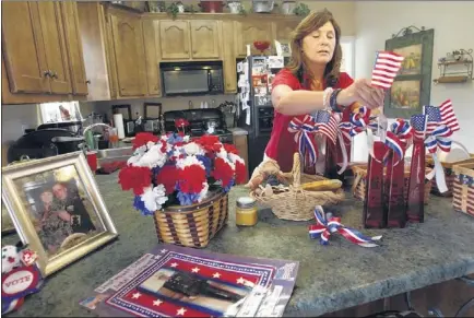  ?? PHOTOS BY STAN CARROLL/THE COMMERCIAL APPEAL ?? “Just think of the bravery of the people who settled and founded this country,” said Supervisor Lee Caldwell, decorating her Nesbit home Wednesday. She said she expects to feed more than 50 friends and family members at an Independen­ce Day celebratio­n...