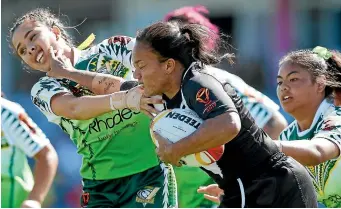  ?? PHOTO: GETTY IMAGES ?? Shontelle Woodman puts a fend on a Cook Islands player during New Zealand’s impressive run to the World Cup final.