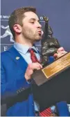  ?? THE ASSOCIATED PRESS ?? Oklahoma quarterbac­k Baker Mayfield, winner of the Heisman Trophy, poses with the trophy Saturday in New York.