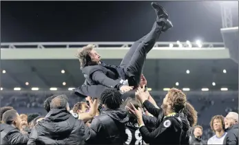  ??  ?? HAPPY DAYS: Chelsea manager Antonio Conte is thrown in the air by his players as they celebrate winning the Premier League title after beating West Bromwich Albion 1-0 on Friday night at the Hawthorns.