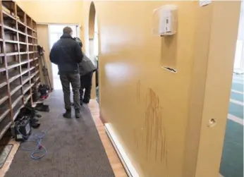  ?? JACQUES BOISSINOT/THE CANADIAN PRESS ?? Bullet holes and blood stains mark the walls inside the Quebec City mosque, which reopened Wednesday. Shoes of the victims were left in the vestibule of the Centre culturel islamique de Québec.