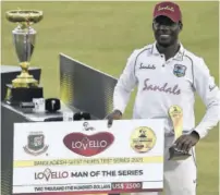  ??  ?? West Indies’ Nkrumah Bonner poses with the Man of the Series trophy after winning the second Test cricket match against Bangladesh at Sher-e-bangla National Cricket Stadium in Dhaka yesterday.