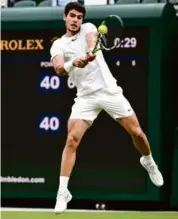  ?? SEBASTIEN BOZON/AFP VIA GETTY IMAGES ?? Top-seeded Carlos Alcaraz took care of Jeremy Chardy in straight sets, but missed playing for the guest of honor.