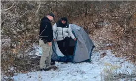  ?? Brigham City, Utah. Photograph: Riverdale Police Department/AFP/Getty Images ?? A police officer speaks to Kai Zhuang at the site where he was found in the mountains near