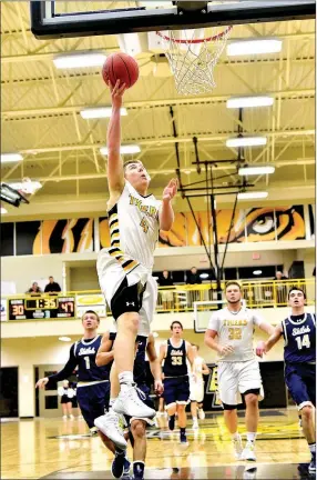  ?? PHOTO BY SHELLEY WILLIAMS ?? Prairie Grove junior Zeke Laird glides in for a layup against Shiloh Christian in the 4A-1 District Tournament in Prairie Grove.