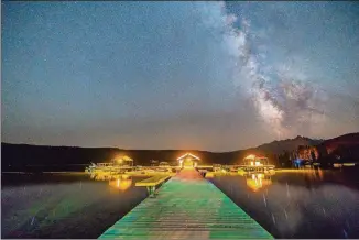  ?? COURTESY OF TRAVIS D. AMICK ?? A view of the Milky Way over the dock at Redfish Lake.