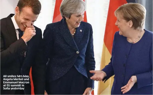  ??  ?? All smiles: Mrs May, Angela Merkel and Emmanuel Macron at EU summit in Sofia yesterday