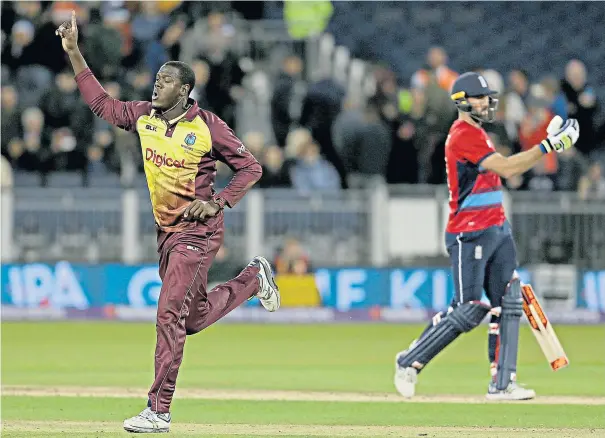  ??  ?? On target: Carlos Brathwaite celebrates taking the wicket of Liam Plunkett