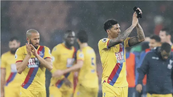  ??  ?? Patrick van Aanholt applauds the travelling fans after making his debut for Crystal Palace in the win at Bournemout­h on Tuesday night