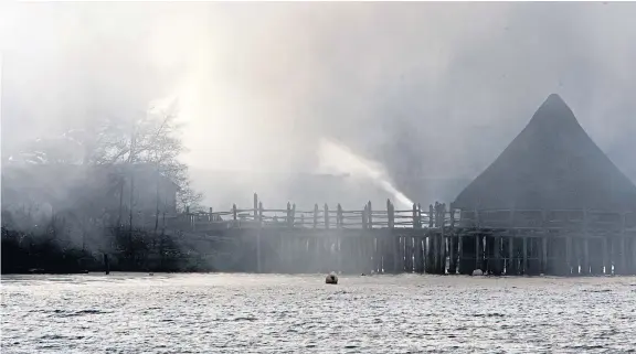  ?? Pictures: Phil Hannah. ?? The fire seen from the loch, with the Scottish Crannog Centre on the right.