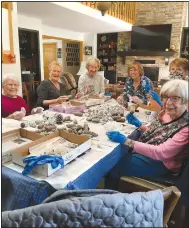  ?? (Submitted photo) ?? Several members of the Bella Vista Chapter of P.E.O. Internatio­nal meet to start decorating pine cones that will be part of numerous swags the group is creating.