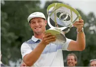  ?? AP ?? Bryson DeChambeau holds up the trophy after winning the Northern Trust golf tournament. —