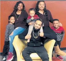  ?? Courtesy of the Hill family ?? Mark Hill, seated, with his wife, Ambrosia Hamilton-Hill, and four of their children. This photo was taken on Christmas Day 2019 by Hamilton-Hill’s niece. He was killed in June. No arrests have been made.