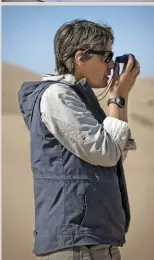  ??  ?? Rachael Ridenour using a compass to
navigate her way through the desert.