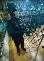  ?? COURTESY PHOTO ?? Lakeport Police Department officer Juan Altamirano handles the rock used to smash up the front window of the store on Sunday.