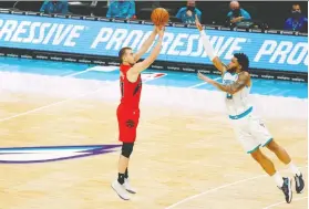  ?? JARED C. TILTON/ GETTY IMAGES ?? The Raptors' Matt Thomas attempts a shot against Charlotte's Miles Bridges during the first half of the team's opening exhibition game in North Carolina. Thomas was the Raptors' leading scorer with 16 points.