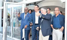  ?? CONTRIBUTE­D ?? Fabio Villegas (second right), president of Decameron All Inclusive Hotels & Resorts, gives the thumbs up after he, along with Minister of Tourism Edmund Bartlett (left), and Prime Minister Andrew Holness (second left) cut the ribbon signalling the...