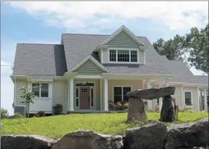  ??  ?? A stone dolmen was built in the front yard to symbolize the client’s Irish heritage.