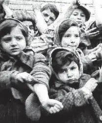  ?? Courtesy photo ?? Some of the 600 children who survived the Auschwitz II-Birkenau show their tattooed identifica­tion numbers in this photo from a Soviet documentar­y. More than 6 million Jews perished, along with millions of others, in the Holocaust. The spiritual...