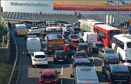  ??  ?? Standstill: Protesters copying the widespread demonstrat­ions seen in the US blocked the approach road to Heathrow airport