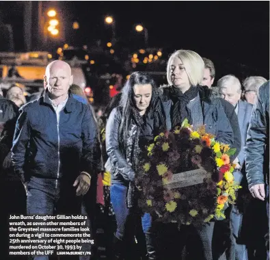  ?? LIAM McBURNEY/PA ?? John Burns’ daughter Gillian holds a wreath, as seven other members of the Greysteel massacre families look on during a vigil to commemorat­e the 25th anniversar­y of eight people being murdered on October 30, 1993 by members of the UFF