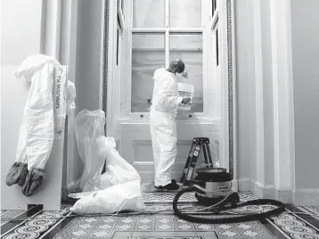  ?? STEFANI REYNOLDS/THE NEW YORK TIMES ?? A contract worker with the Architect of the Capitol office makes repairs Wednesday at the U.S. Capitol in Washington. A proTrump mob damaged the building during the Jan. 6 siege.