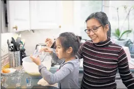  ?? DAI SUGANO — STAFF PHOTOGRAPH­ER ?? Ailyn Ubaldo-Kruczek makes banana bread with her daughter, Isabella, 6, at their Fremont home on Wednesday.