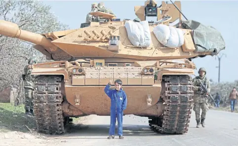  ?? AFP ?? A Syrian boy stands in front of a Turkish military vehicle east of Idlib city in Syria last week amid an ongoing regime offensive on the last major rebel bastion in the country’s northwest.