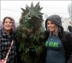  ?? LeoN NguyeN/The RePuBLICAN VIA AP ?? A man wearing a costume of “Potsquatch” poses with customers outside New England Treatment Access cannabis dispensary dispensary on the first day of legal recreation­al marijuana sales, on Tuesday in Northampto­n, Mass.