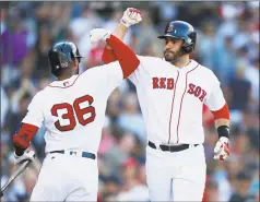  ?? Michael Dwyer / Associated Press ?? The Boston Red Sox’s J. D. Martinez celebrates his solo home run with Eduardo Nunez during the fourth inning on Saturday.