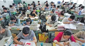  ?? Photo: Xinhua ?? The central government will add funding to support compulsory and vocational education in central and western regions, poverty-stricken and rural areas.