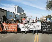  ?? JAY JANNER/AUSTIN AMERICAN-STATESMAN ?? Marchers block traffic Jan 20 next to the University of Texas in Austin as they voice opposition to Donald Trump.