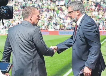  ??  ?? Brendan Rodgers and Craig Levein exchange a warm handshake – before last May’s game