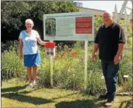  ?? PHOTO COURTESY CORNELL COOPERATIV­E EXTENSION OF ONEIDA COUNTY ?? Sarah Scripture McDade, left, and Paul Sears, CCE Oneida Board of Directors President, unveil the new Parker F. Scripture Botanical Gardens sign.