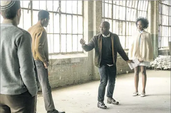  ?? Tatum Mangus Annapurna Pictures ?? BARRY JENKINS, center, directs Stephan James, second from left, and KiKi Layne in an adaptation of James Baldwin’s “If Beale Street Could Talk,” opening Dec. 14.