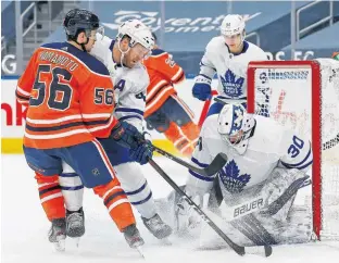  ?? PERRY NELSON • USA TODAY SPORTS ?? Toronto Maple Leafs goaltender Michael Hutchinson makes a save against Edmonton Oilers’ Kailer Yamamoto during NHL action in Edmonton on Monday night.