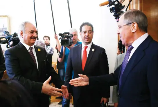  ??  ?? Russian Foreign Minister Sergey Lavrov, right, welcomes Gen. Khalifa Haftar, commander in the Libyan National Army (LNA), during a meeting in Moscow on Monday. (Reuters)